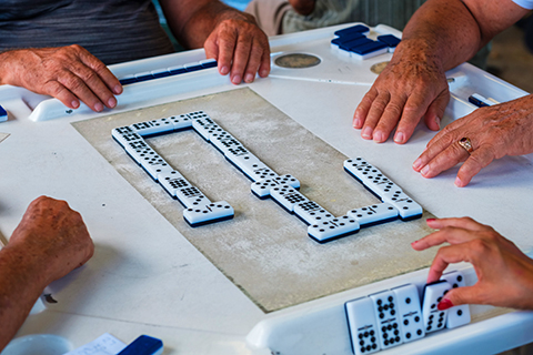 A stock photo of an up close view of a game of dominos.