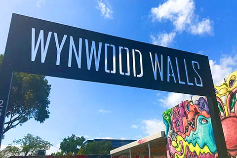 A stock photo of the sign at Wynwood Walls in the Wynwood Art District of Miami, Florida.