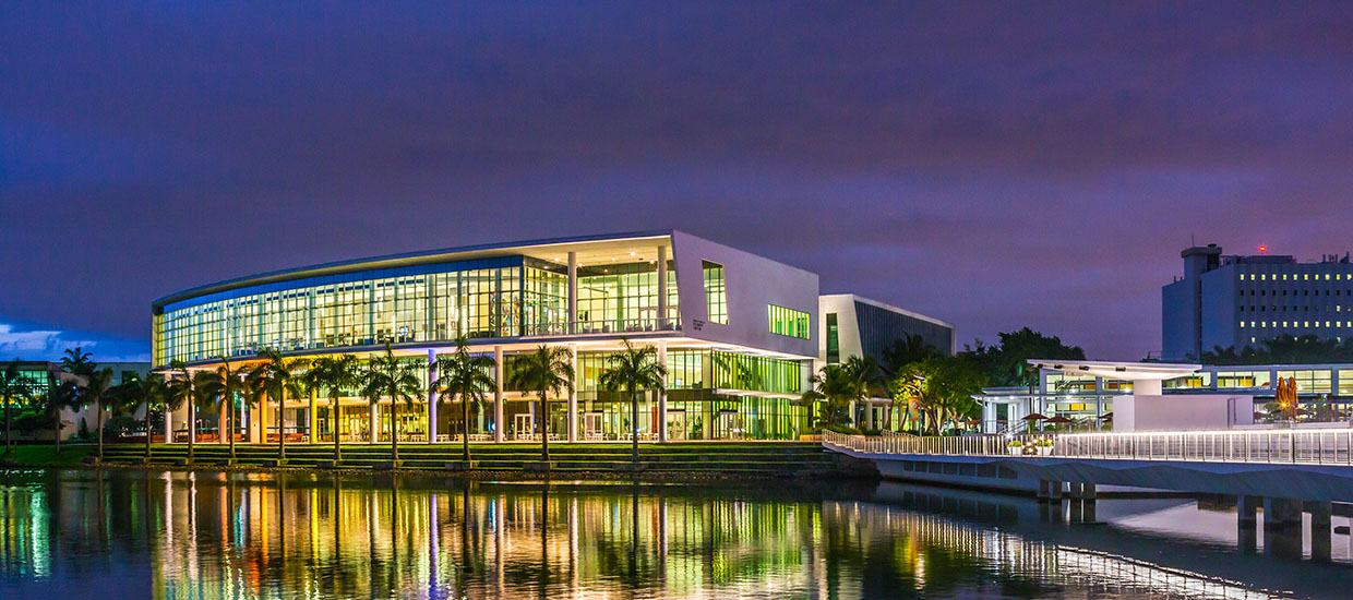 A photo of the University of Miami Shalala Student Center at night.